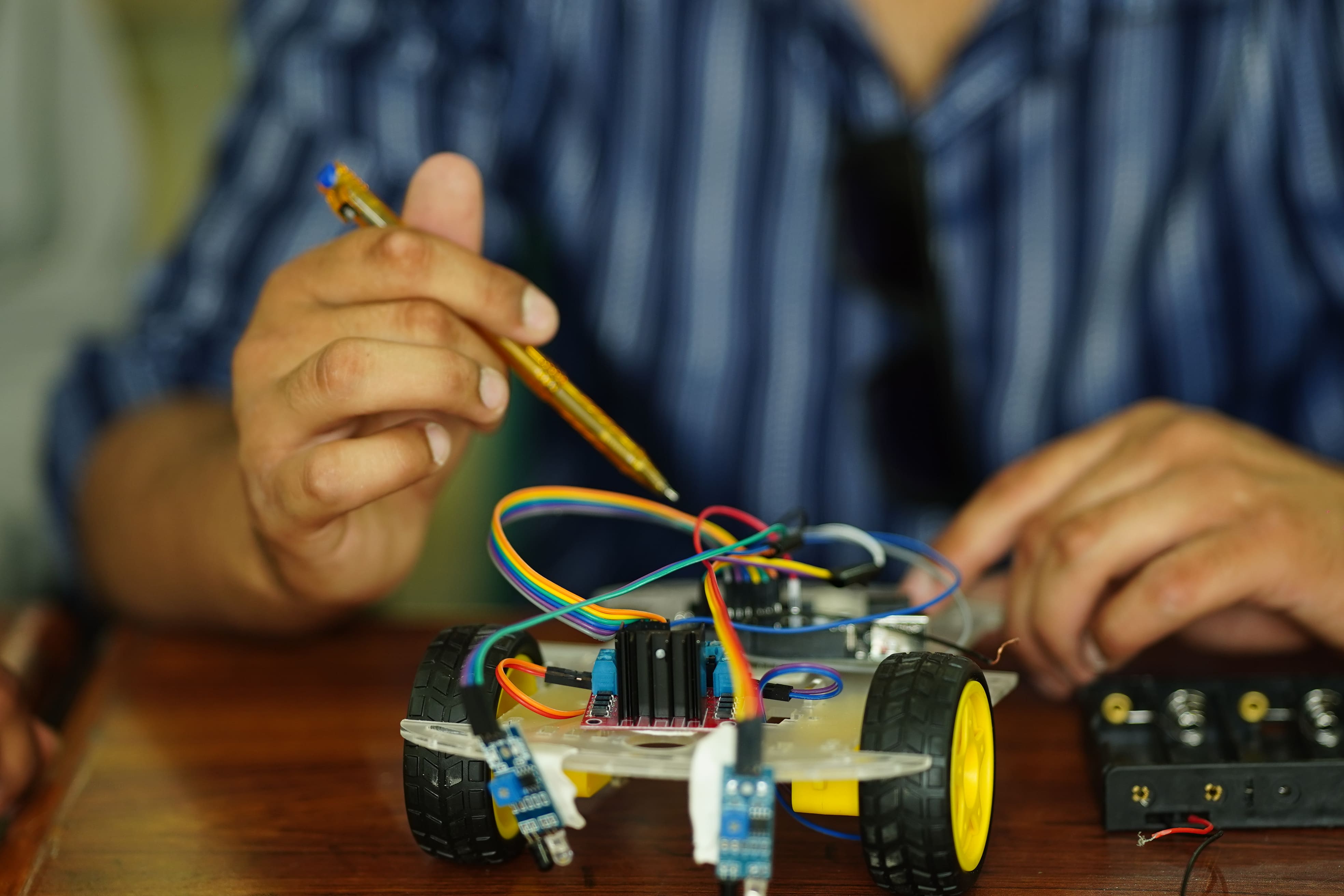 Student troubleshooting circuit on breadboard